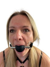 Load image into Gallery viewer, Person wearing a Black silicone ball gag with adjustable leather strap