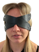 Load image into Gallery viewer, Person wearing a black leather blindfold with metal studs on a white background