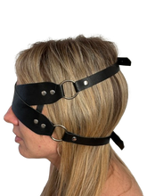 Load image into Gallery viewer, Side view of a person wearing adjustable leather blindfold with buckle strap