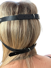 Load image into Gallery viewer, back of someone head wearing a black leather blindfold showing straps