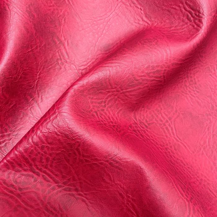 A close-up of textured red leather fabric with soft folds and a glossy sheen.